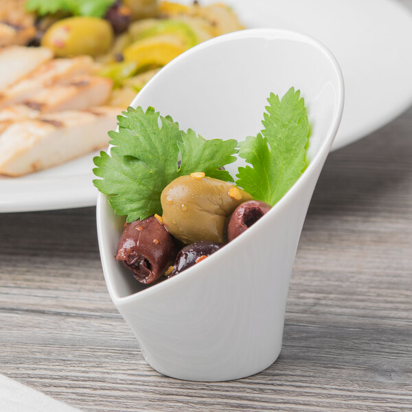 A Schonwald white porcelain bowl with olives and parsley.