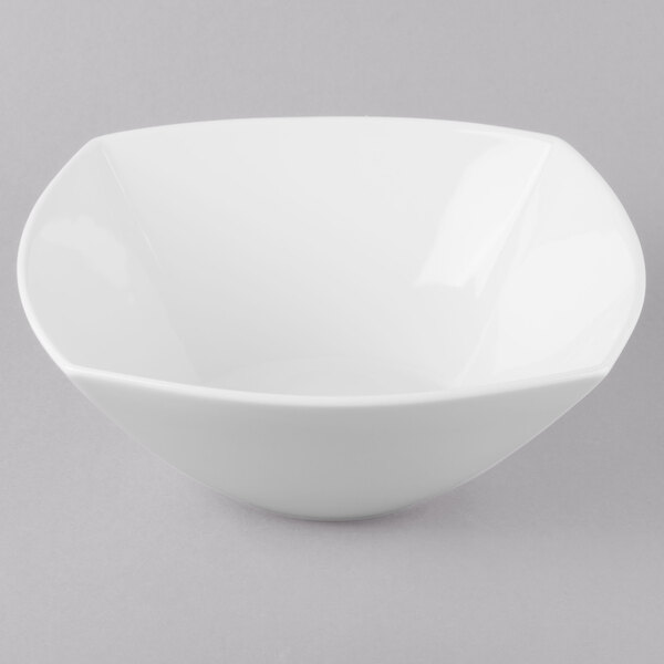 A Schonwald white porcelain bowl with a white rim on a gray surface.
