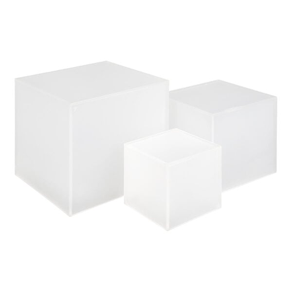 Three frosted, translucent acrylic cubes of varying sizes are arranged together on a white background.