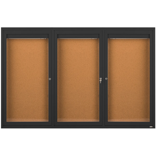 A brown board with a black frame and three black glass doors.