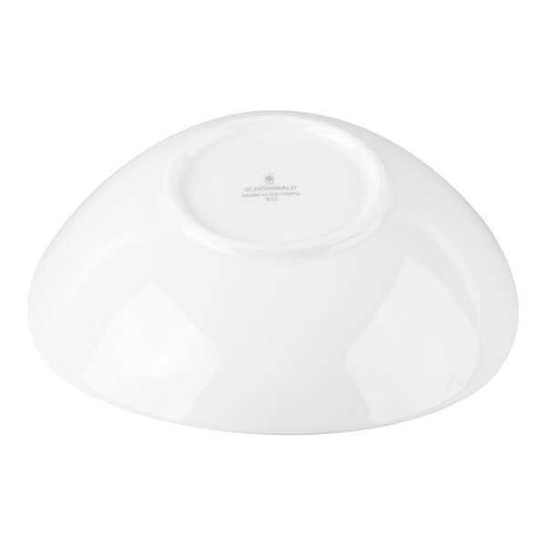 A white porcelain bowl shown upside down, displaying its smooth, glossy surface and the manufacturer's mark on the base.