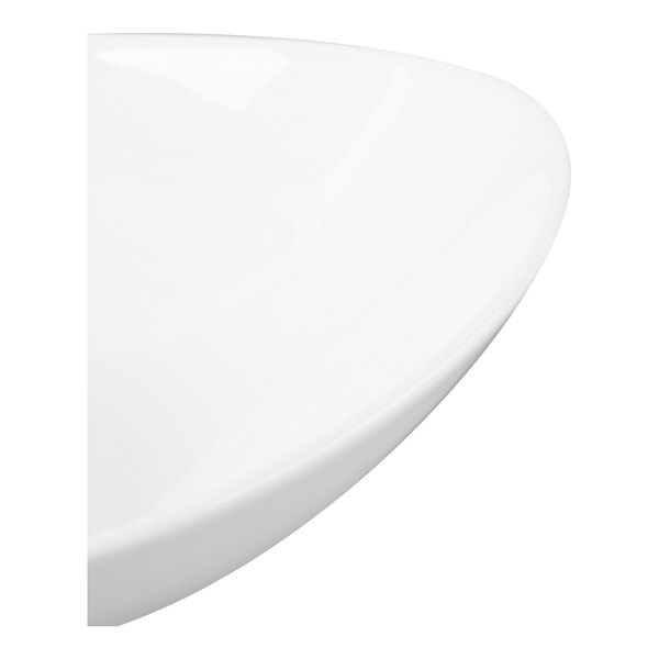 A close-up view of a smooth, glossy white curved porcelain surface, likely part of a bowl.