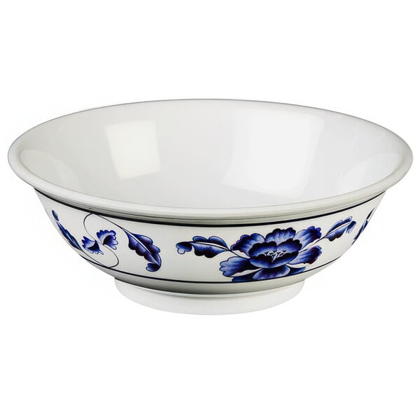 A white Thunder Group melamine bowl with blue flowers on it.