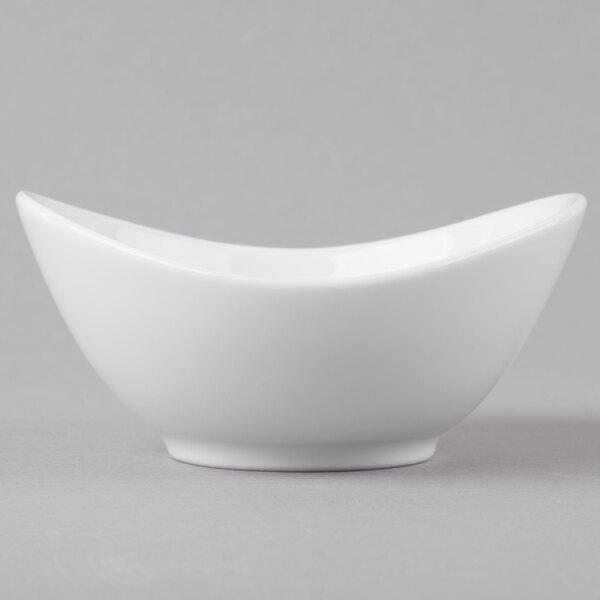 A Schonwald Grace white porcelain dip dish with a curved edge.