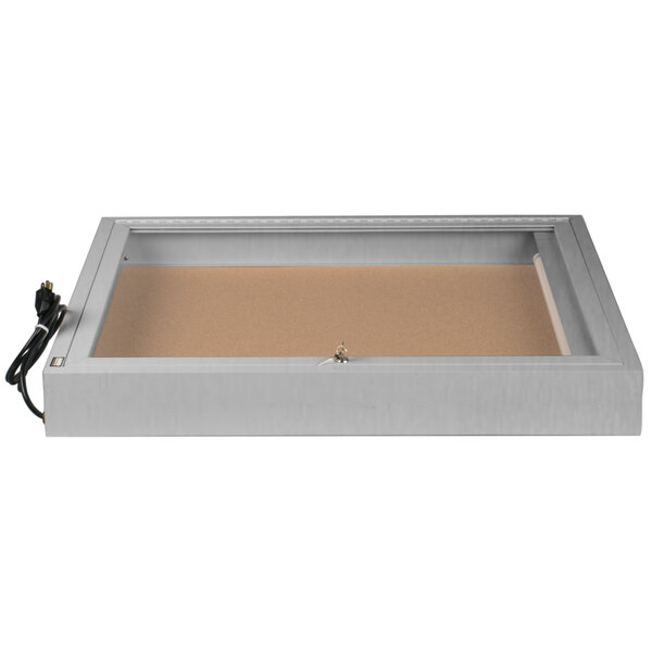 An Aarco satin anodized finish rectangular box with a cork board inside and a key attached to the front.