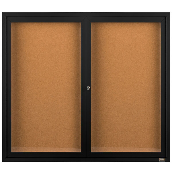 A black Aarco enclosed bulletin board cabinet with cork boards inside.