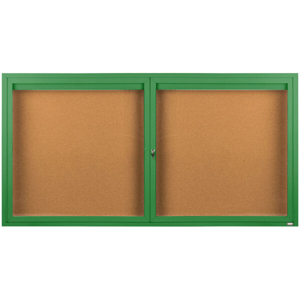 A brown bulletin board cabinet with green frame and two enclosed green bulletin boards with two doors.