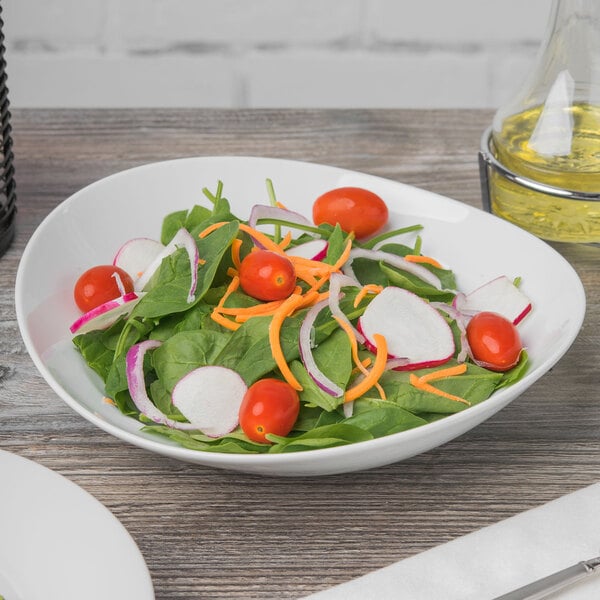 A Schonwald Grace white porcelain bowl filled with a vegetable salad on a table.