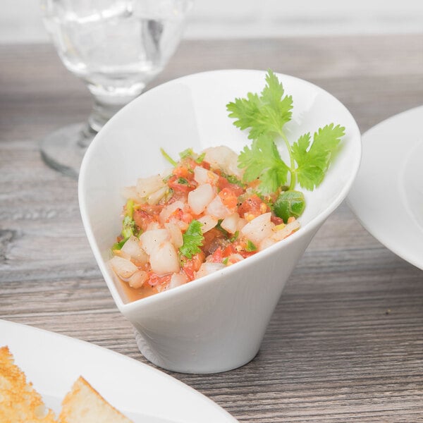 A white Schonwald Calla bowl with food on a table.