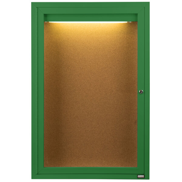 A green cabinet with a lighted bulletin board inside.