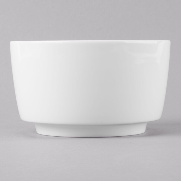 A Schonwald white jam jar with a white rim on a gray surface.