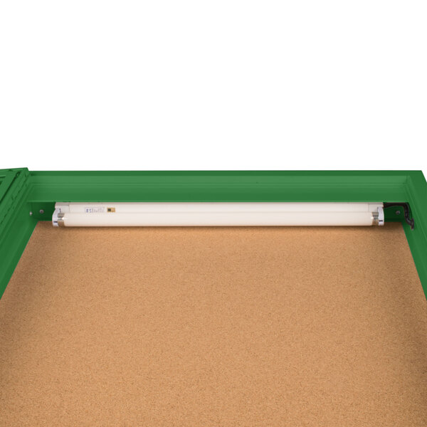 An Aarco green enclosed bulletin board cabinet with a light.