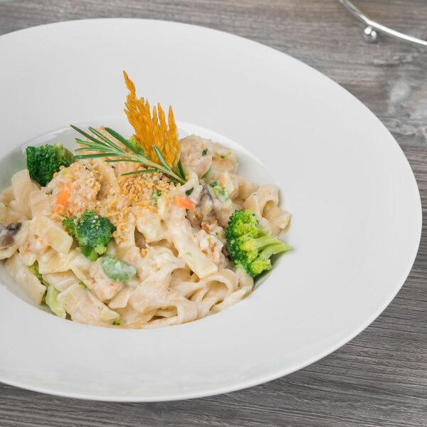 A Schonwald white porcelain pasta bowl with pasta, broccoli, and cheese.