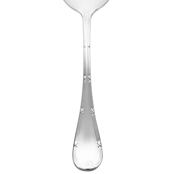A close-up of a Chef & Sommelier stainless steel soup spoon with a design on the handle.