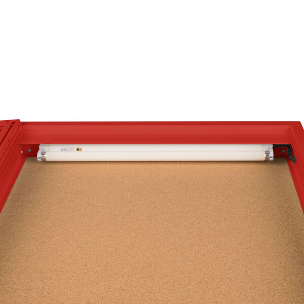 A red Aarco indoor lighted bulletin board cabinet.