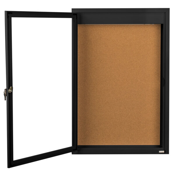 A black rectangular frame with a white background and a black framed notice board with a white door.
