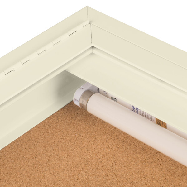 An ivory Aarco lighted enclosed bulletin board with a cork background.