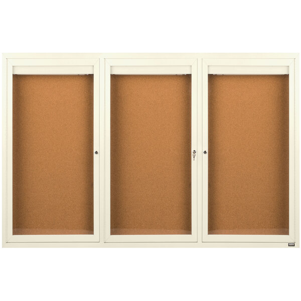 A brown board with a white border and three glass doors.