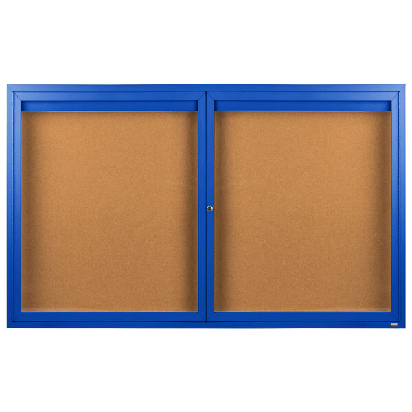A blue framed bulletin board with two doors and a brown board.