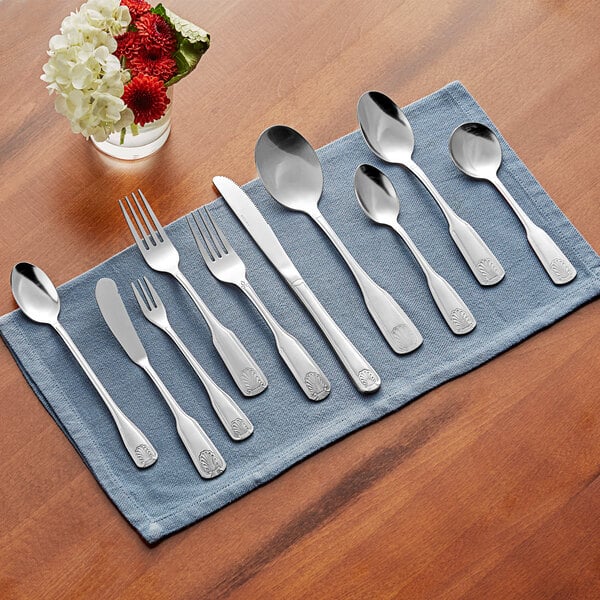 A close-up of a set of Acopa stainless steel cocktail/oyster forks.