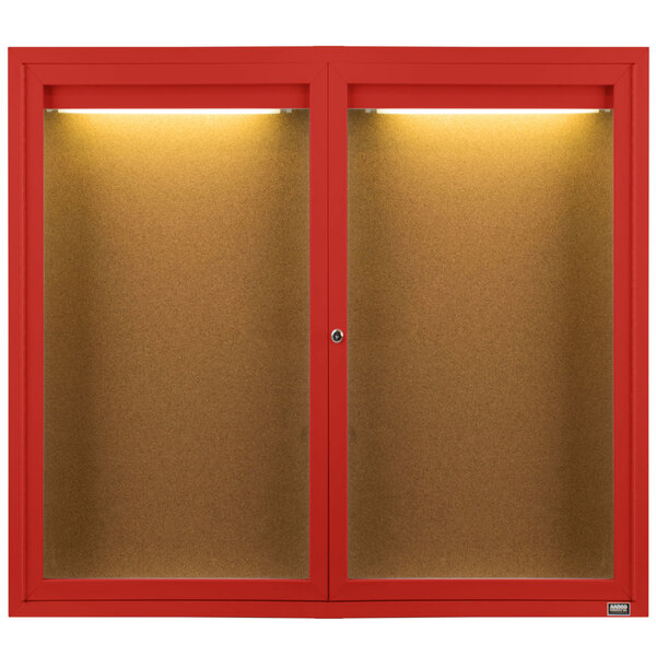 A red Aarco bulletin board cabinet with two doors and lights on them.