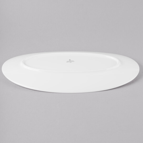 A Schonwald Grace white porcelain oval platter on a gray surface.