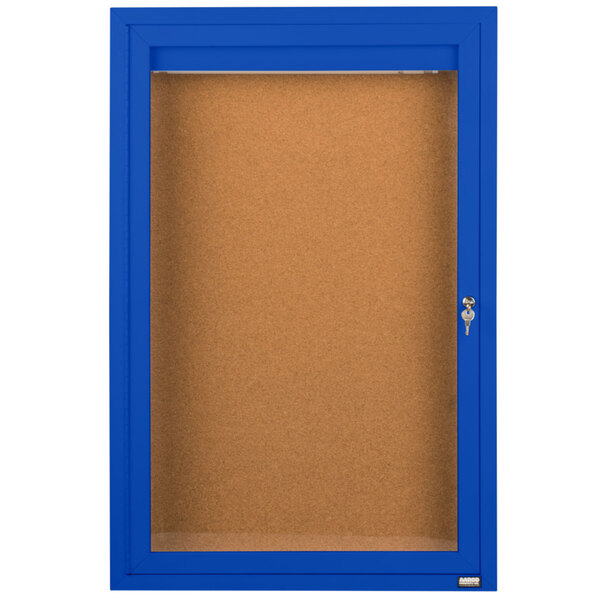 A blue Aarco indoor bulletin board cabinet with a glass door and key.
