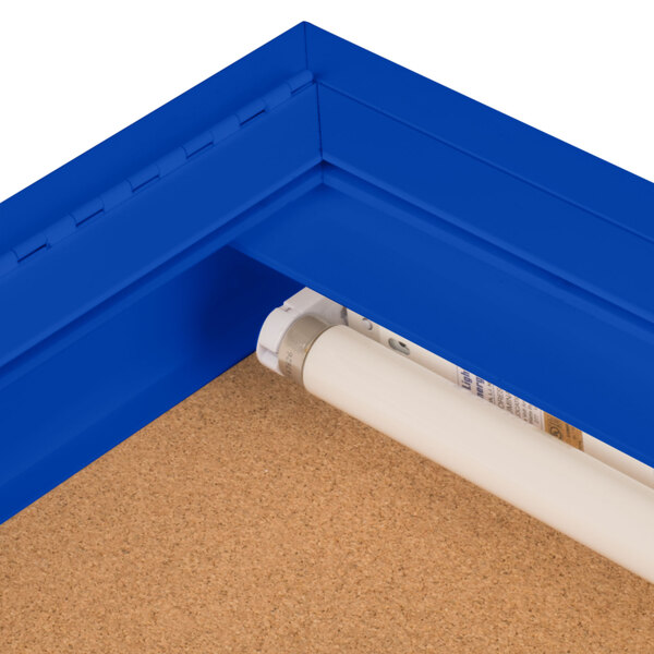 An indoor blue bulletin board cabinet with a white tube.