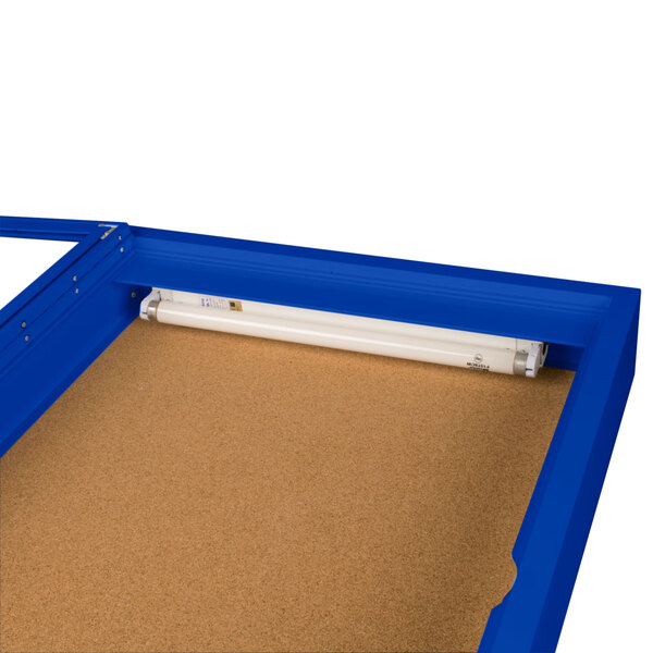 An Aarco blue and white rectangular enclosed bulletin board cabinet with a light inside.