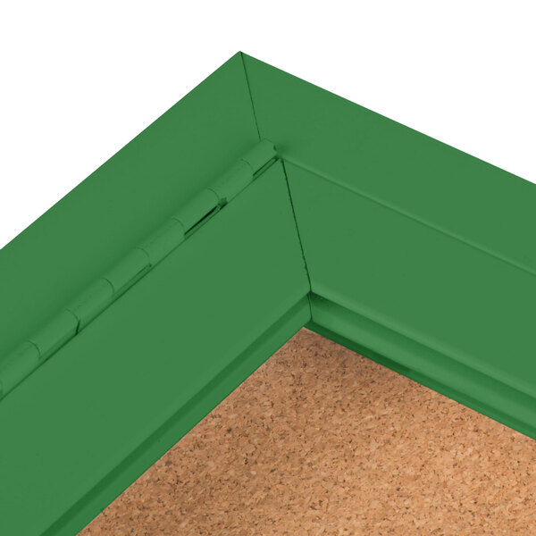 The corner of a green Aarco bulletin board cabinet with cork board inside.