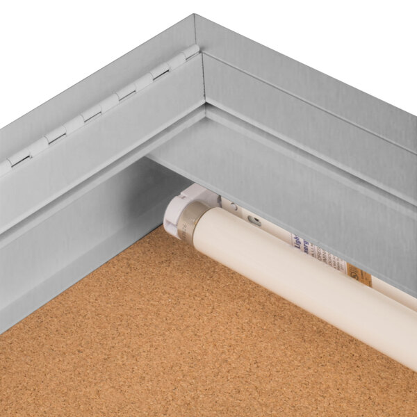 An Aarco satin anodized metal bulletin board cabinet with a hinged door.