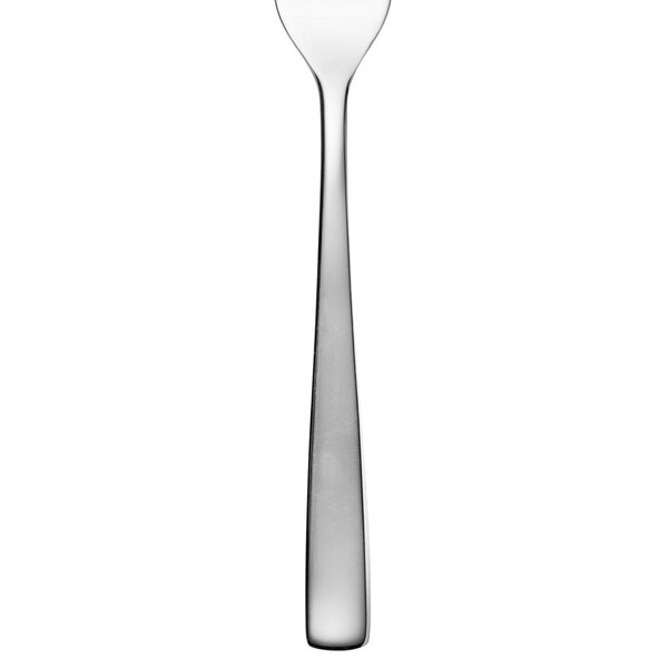 An Arcoroc stainless steel oyster fork with a white handle.