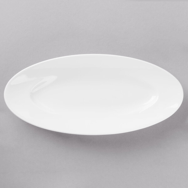 A white porcelain long tray on a gray surface.