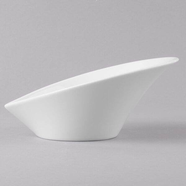 A close-up of a Schonwald Grace white porcelain Calla bowl with a curved shape.