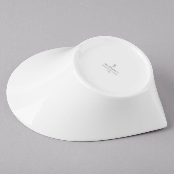 A white Schonwald Calla bowl on a gray surface.