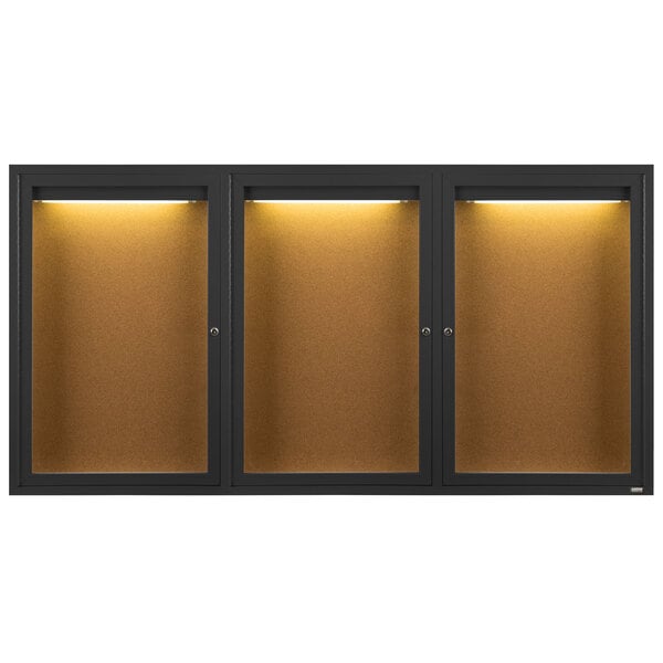 A row of three black Aarco bulletin board cabinets with lights.