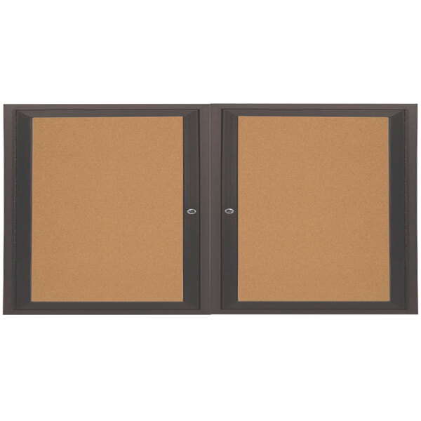 An Aarco enclosed bulletin board cabinet with bronze anodized doors.