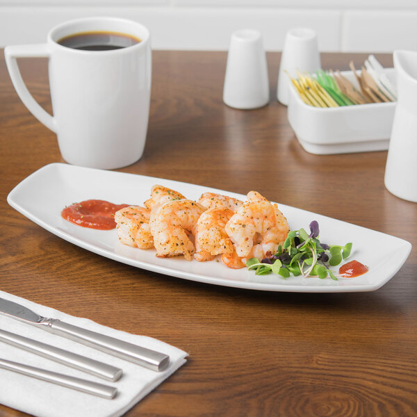 A white Schonwald porcelain long tray with shrimp and sauce on it.