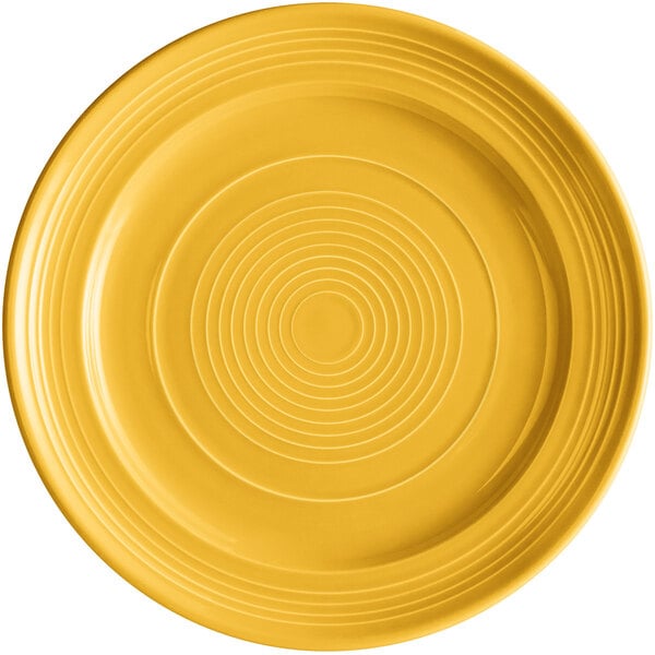 A yellow Tuxton Concentrix china plate with white concentric circles.