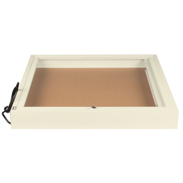 An ivory rectangular box with a brown surface and a white border with a light inside.