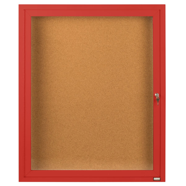 A red Aarco indoor bulletin board cabinet with a glass door and key lock.