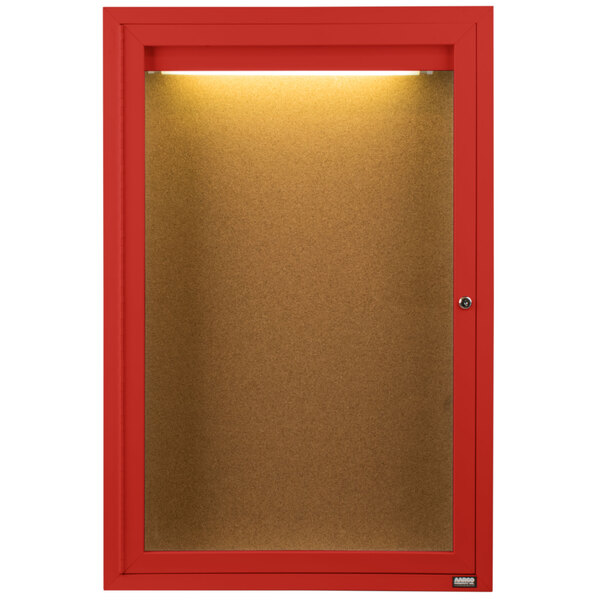 A red indoor lighted bulletin board cabinet with 1 door.