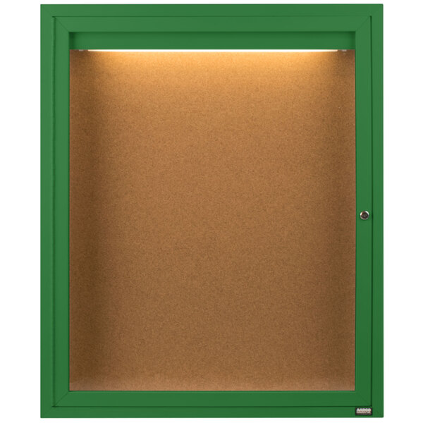 A green framed enclosed bulletin board with lights.