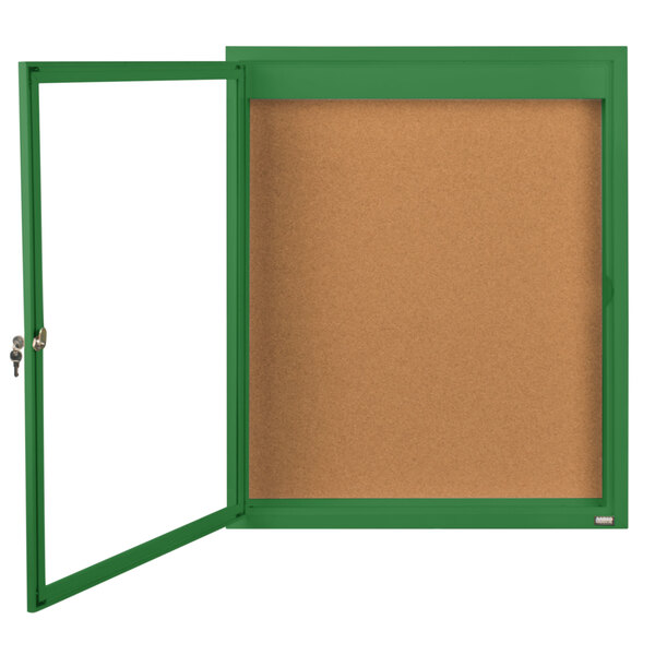 A green framed bulletin board with a door open.