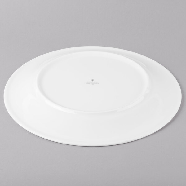 A Schonwald white porcelain plate with a small circular design.