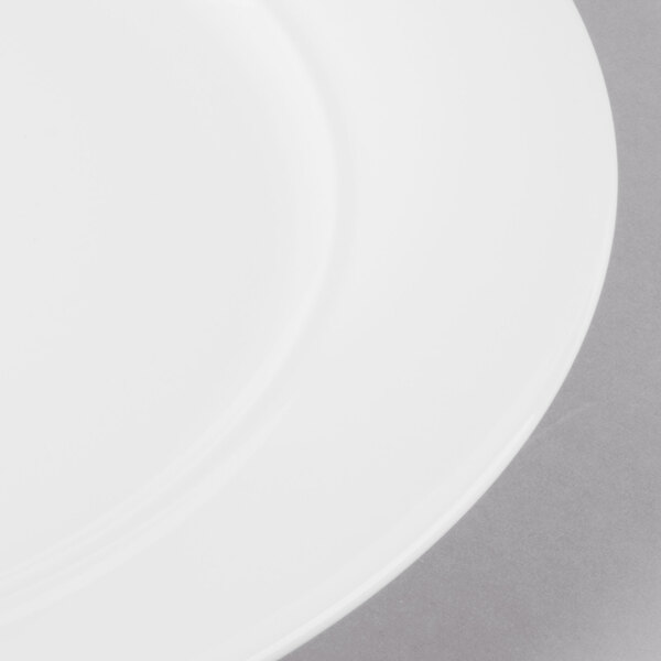 A close-up of a Schonwald Continental white porcelain plate with a white rim.