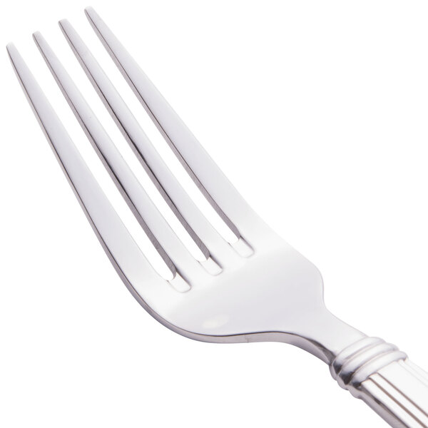 A close-up of a Libbey stainless steel utility/dessert fork with a silver handle.