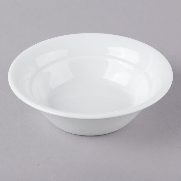 A Schonwald Avanti Gusto white porcelain bowl on a gray surface.
