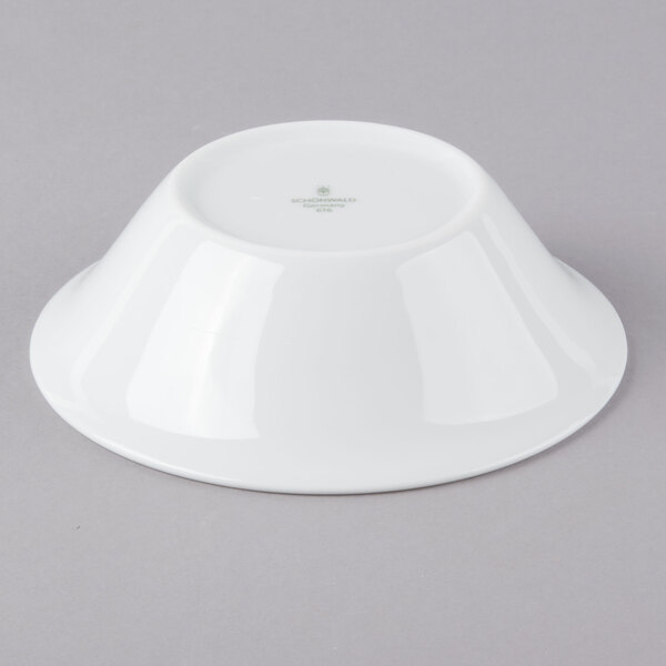 A Schonwald Avanti Gusto white porcelain bowl on a gray surface.