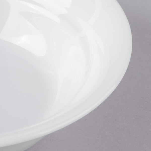 A close-up of a Schonwald Avanti Gusto white porcelain bowl with a white rim.